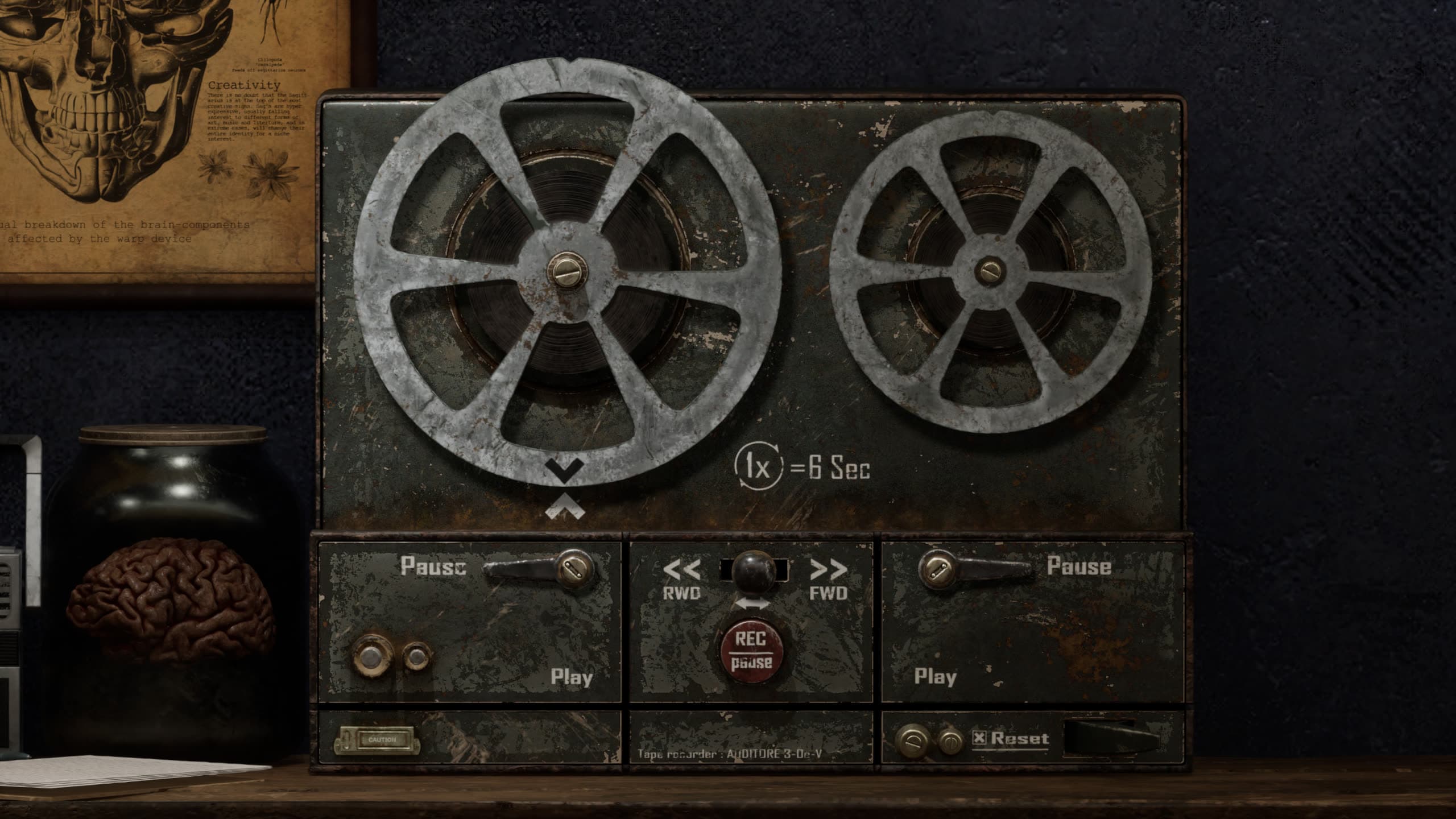 Reel-to-reel tape recorder on a desk beside archival charts